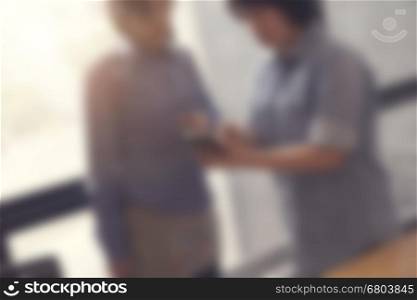 women look at mobile phone in meeting room, selective focus and vintage tone