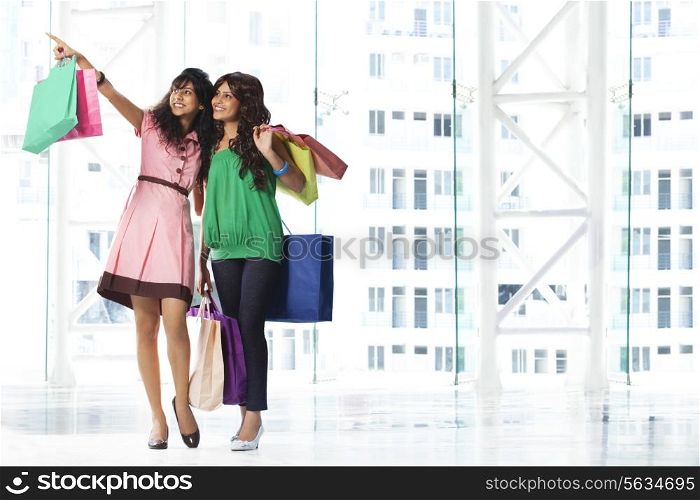 Women looking at something while shopping