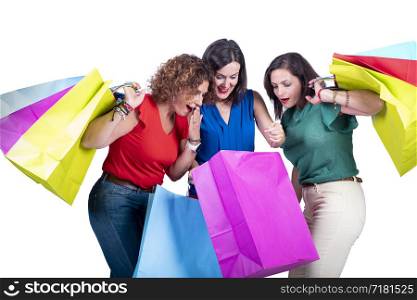 women looking at the shopping inside the bags and surprising themselves on a white background.