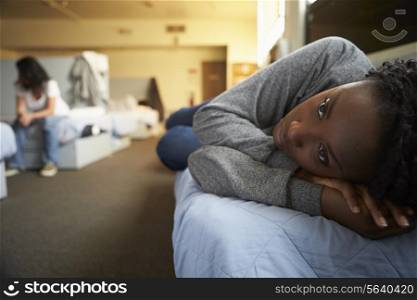 Women Lying On Beds In Homeless Shelter
