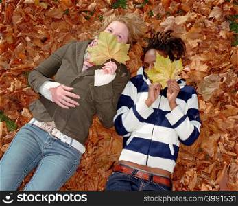 Women lying on leaves