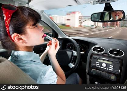 women make up lips at the wheel the car