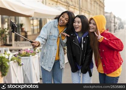 women making selfie using selfie stick 2