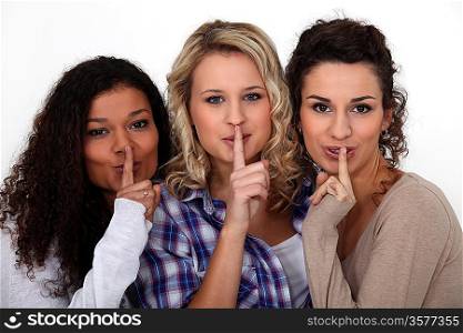 Women making shush gesture