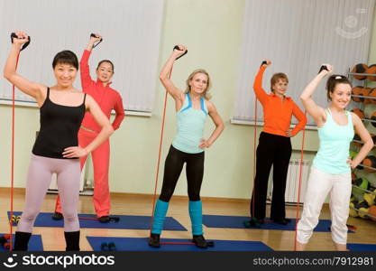 Women of Different Age (from 18 to 50) Doing Aerobics with Dumbbells