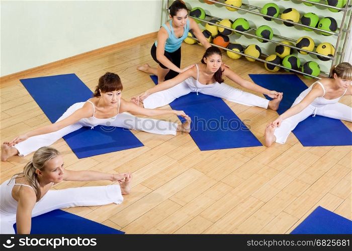 Women of different ages and nationalities are engaged in fitness in the gym.