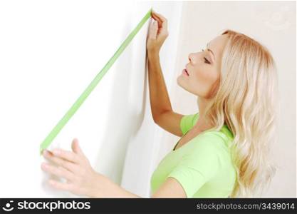 women often with a measuring tape to the wall