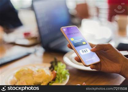 Women pay for food Using credit cards through mobile phones in restaurants, future IOT and technology concepts