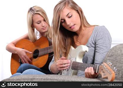 Women playing the guitar.