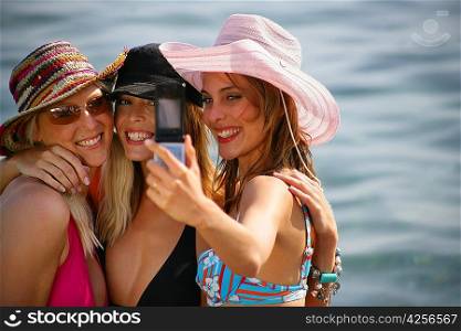 women posing for picture on the beach