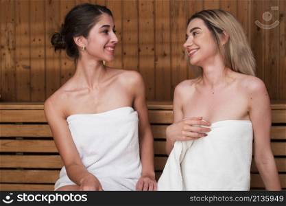 women posing while looking each other sauna