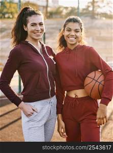 women posing with basketball