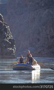 Women Rafting on River Through Canyon