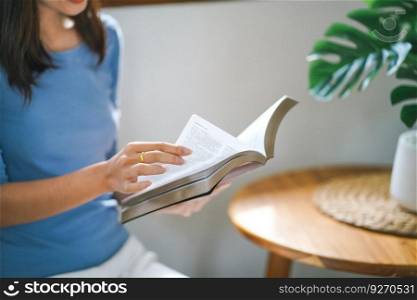 Women reading book and relaxing at home and comfort in front of opened book.