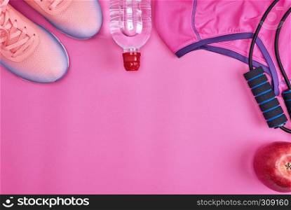 Women's clothing set for fitness on a pink background, copy space