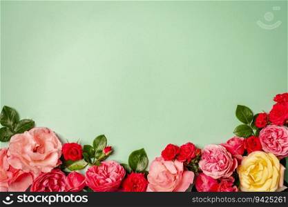 Women&rsquo;s Day concept. Top view photo of pink rose buds and sprinkles on isolated pastel green background with copy space. Top view photo of pink rose