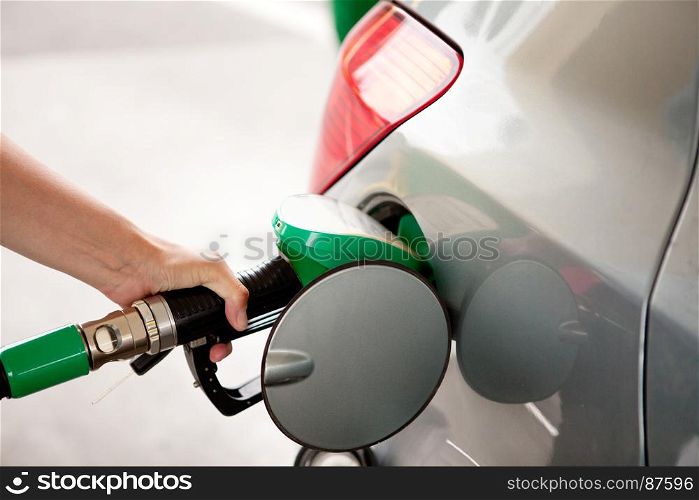 Women's Hand Refueling the Car at a Gas Station