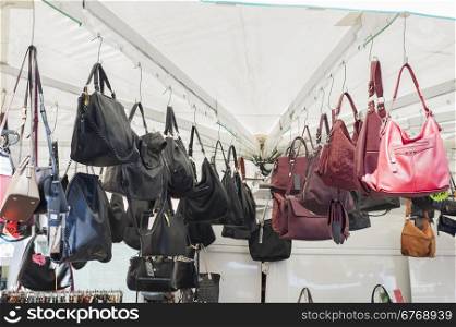 Women&rsquo;s handbags for sale at an outdoor market