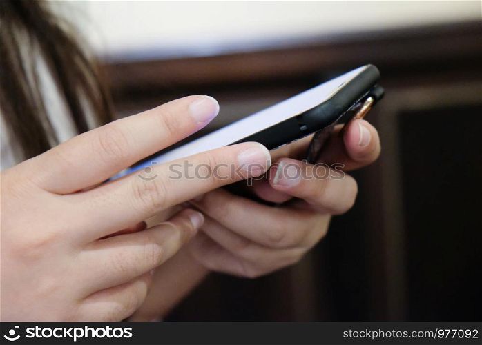 Women's hands holding cell telephone watching social media in a smart phone. social network concept with smart phone.