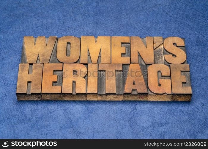 women&rsquo;s heritage word abstract in vintage letterpress wood type against blue handmade paper
