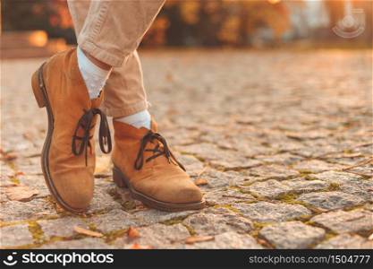 Women&rsquo;s legs in elegant autumn nubuck boots. At sunset in the city. Women&rsquo;s legs in elegant autumn nubuck boots. At sunset in the city.