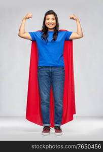 women&rsquo;s power and people concept - happy asian woman in red superhero cape over grey background. happy asian woman in red superhero cape