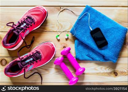 Women&rsquo;s running shoes and dumbbells for training