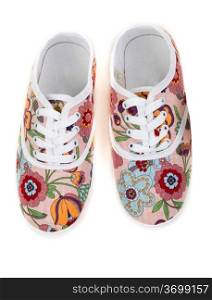 women&rsquo;s sneakers with floral pattern isolated on a white background