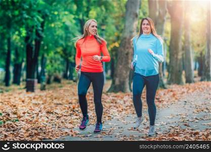 Women Running in Public Park in the Fall.