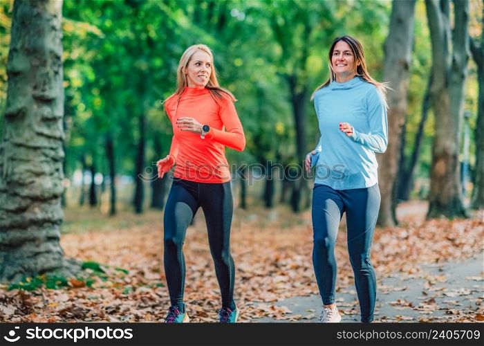 Women Running in Public Park in the Fall.