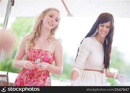 Women setting table outdoors