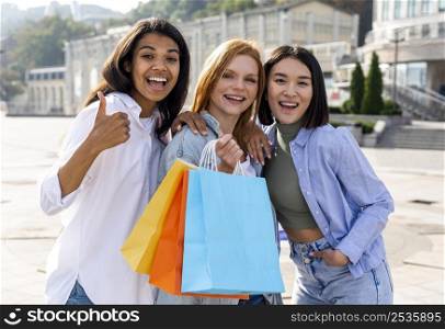 women shoeing their shopping bags outdoors