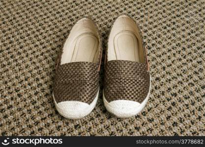 women shoes on woven carpet