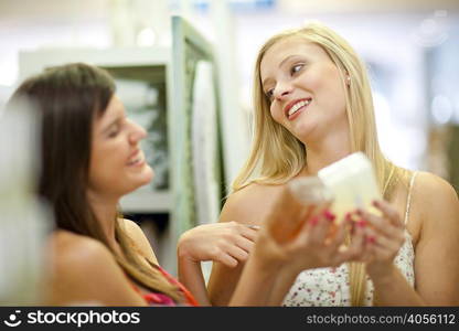 Women shopping for candles in store