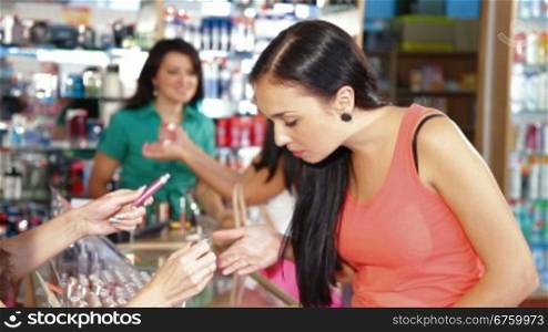 Women Shopping for Makeup Products in Beauty Department
