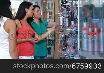 Women Shopping in Cosmetics Store, Choosing Hairbrush