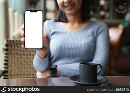 women sit back and relax in the hotel restaurant, feeling happy showing phone white blank screen