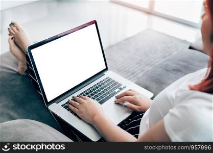 Women sitting couch in a living room and laptop blank screen.
