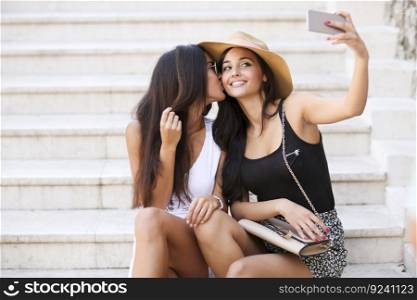 Women sitting on the stairs and taking selfie