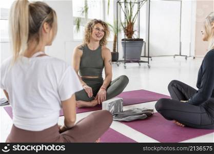 women sitting yoga mats