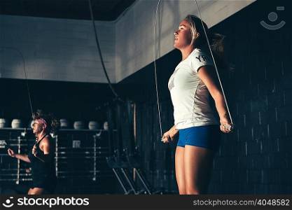 Women skipping with skipping ropes in gym