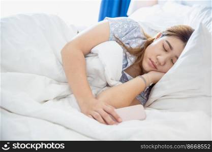 women sleeping in cozy white bed, Asian chubby young fat girl rest with cellphone.