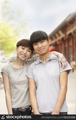 Women smiling and embracing outdoors