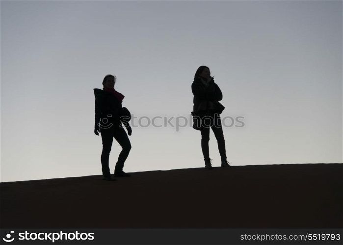 Women standing on Erg Chegaga Dunes in Sahara Desert, Souss-Massa-Draa, Morocco