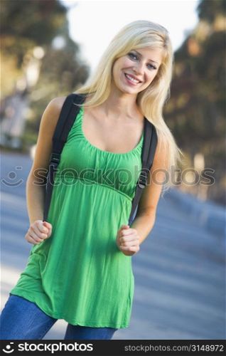 Women standing outdoors smiling (selective focus)