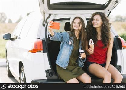 women taking selfie trunk