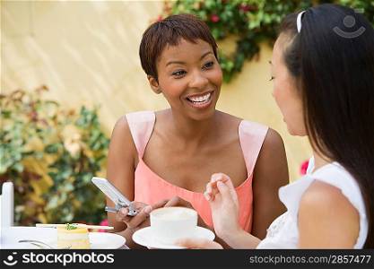 Women talking at outdoor table