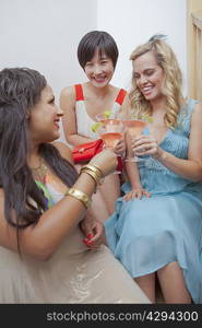 Women toasting each other with martinis