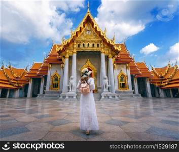 Women tourists at Wat Benchamabophit or the Marble Temple in Bangkok, Thailand.