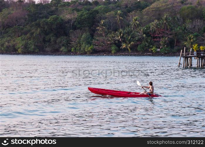 Women tourists wear bikini set kayaking in sea beautiful area ao bang bao at Koh Kood island Trat, Thailand.